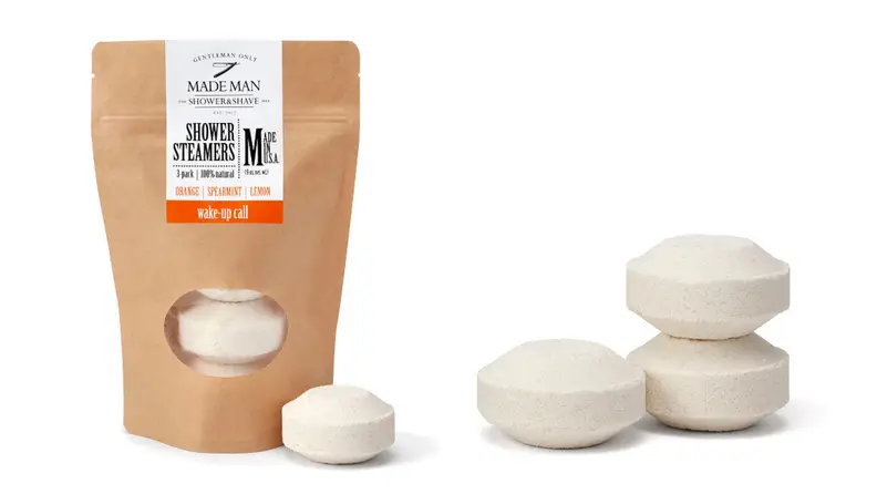 On right, product shot of paper pouch of essential oil steamers. On right, three white oil shower diffusers.