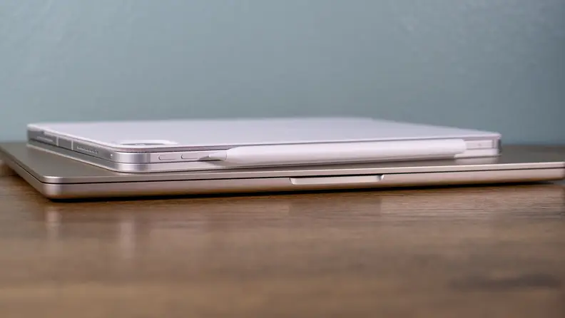 A MacBook Air and an iPad Pro sit on a desk