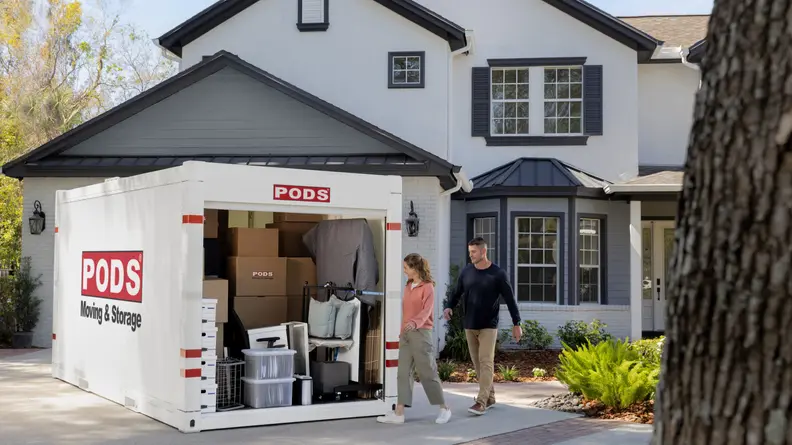 A large portable storage unit in front of a house