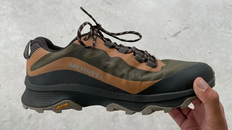hand holding Merrell Moab Speed shoe