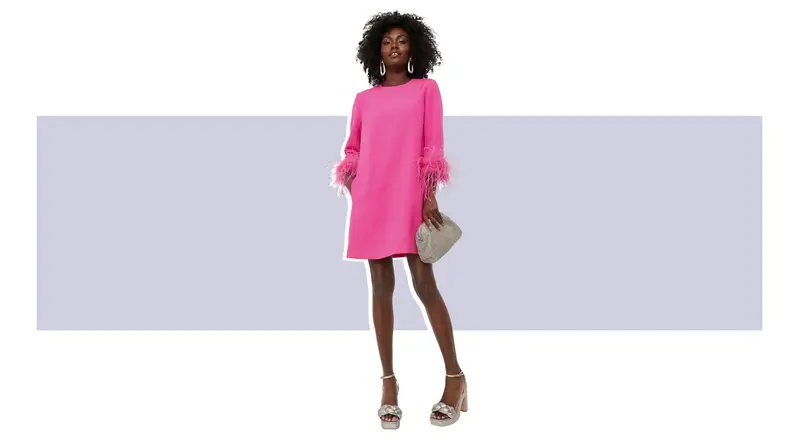 A bright pink mini dress with long sleeves and pink feathers at the cuffs.