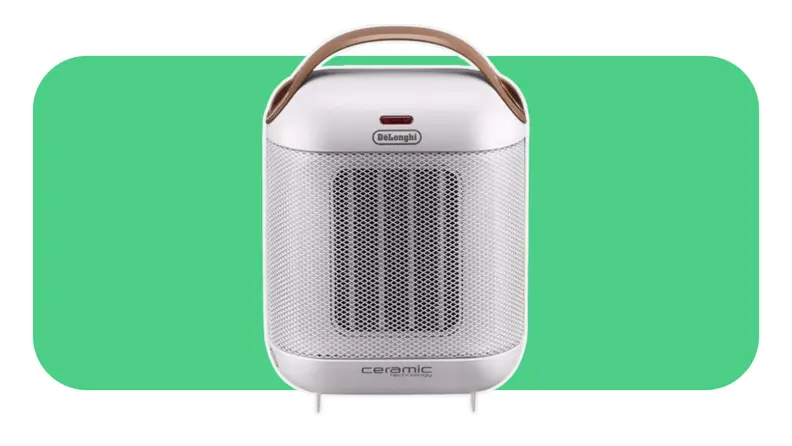 A white Delonghi Capsule space heater on a green background.