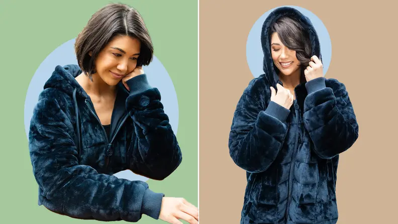 Model poses while sitting and standing while wearing a plush, midnight blue weighted hoodie.