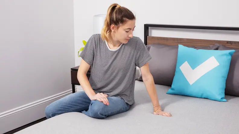 A person sitting on The Casper foam mattress.