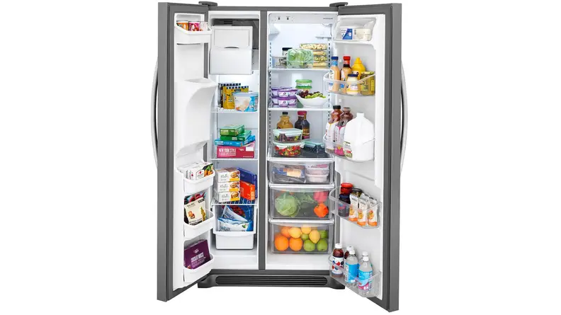 The Frigidaire FFSS2615TS side-by-side refrigerator with both doors flung open, filled to the brim with groceries.