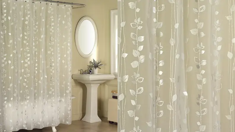 A shower curtain with a gold ivy print.
