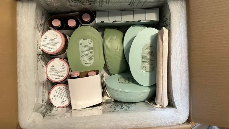 Methodology shipping box open, revealing containers of food