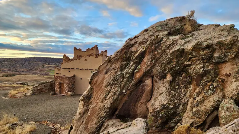 Front view of a guest ranch behind a huge rock