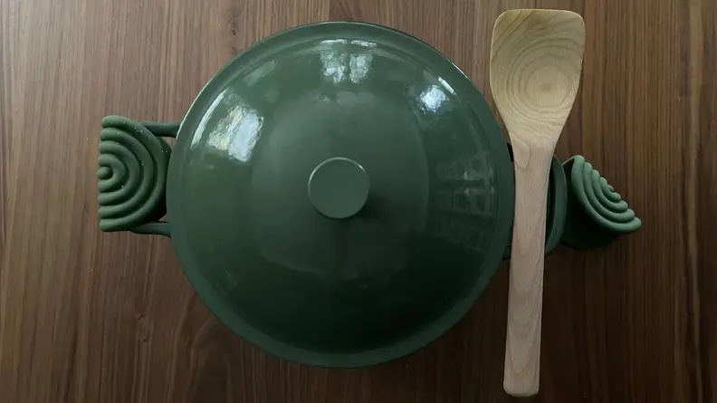 Our Place’s Cast Iron Perfect Pot in sage green color with sage green Hot Grips tools.
