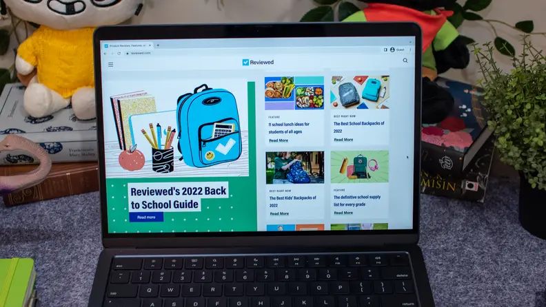 MacBook Air 13 M2 laptop computer in Midnight color with display opened to website browser.