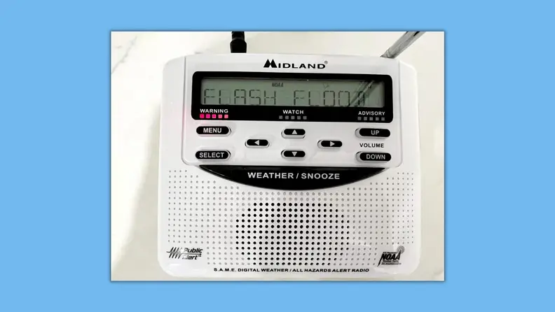 The weather radio with a flash flood warning on display.