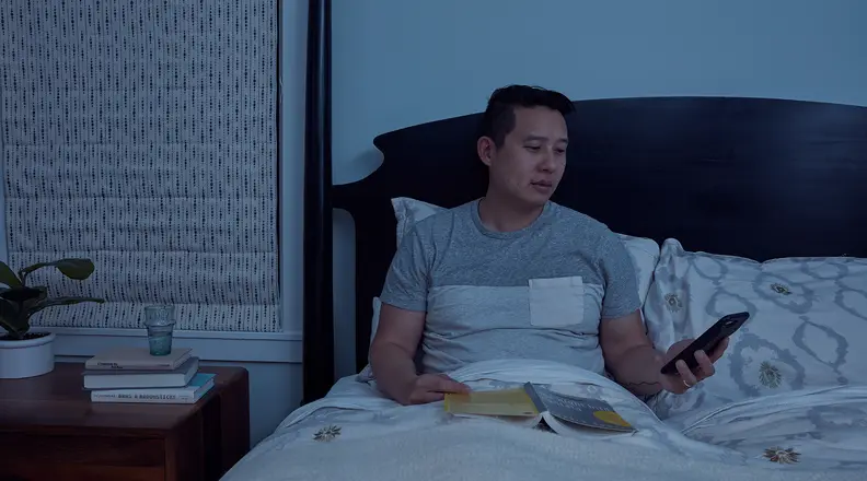 Parent on phone in bed