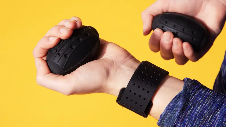 Person wearing Liteboxer wrist straps holds egg shaped weights.