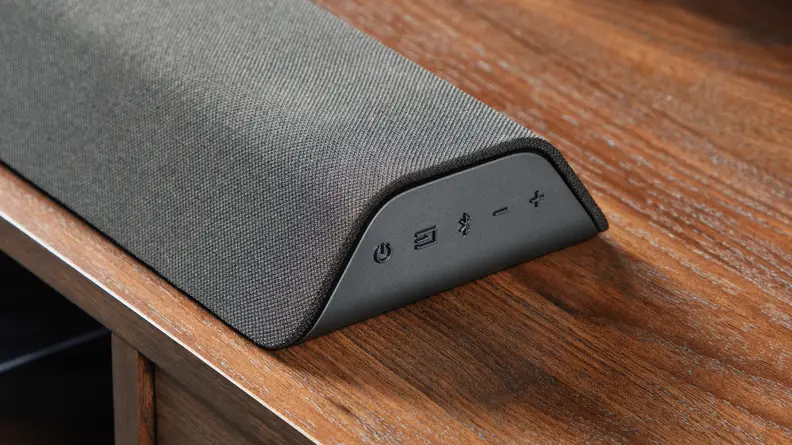 A close-in image of one end of a Vizio M-Series All-in-One M213AD-K8 Dolby Atmos Soundbar.