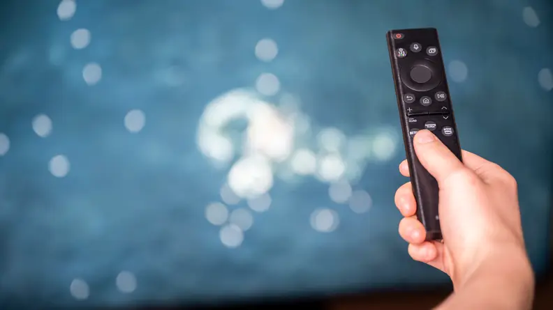 A close-up of the Samsung Solar Cell remote control being held in someone's hand