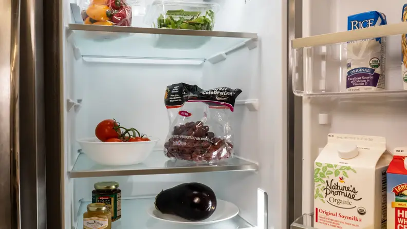 A shot of the interior of the Frigidaire Gallery GRSC2352AF side-by-side refrigerator's fridge compartment. It's full of food to help establish scale.