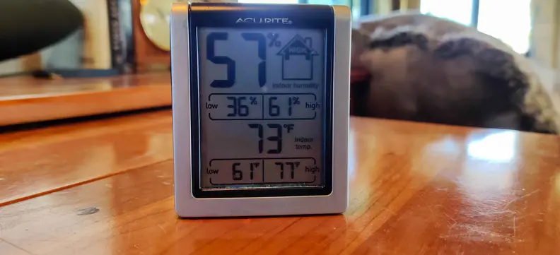 A thermometer registers 57 percent humidity and 73 degrees during testing of the best window AC units.