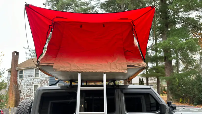 Profile of the Rugged Ridge Roof Top Tent set up over a gray Jeep Wrangler Rubicon.