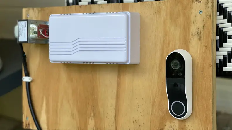 A video doorbell mounted to a wood testing rig