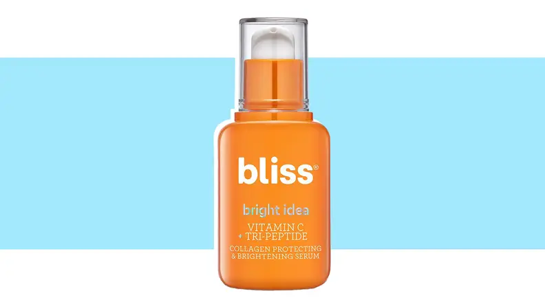 A bottle of vitamin C serum against a blue background.