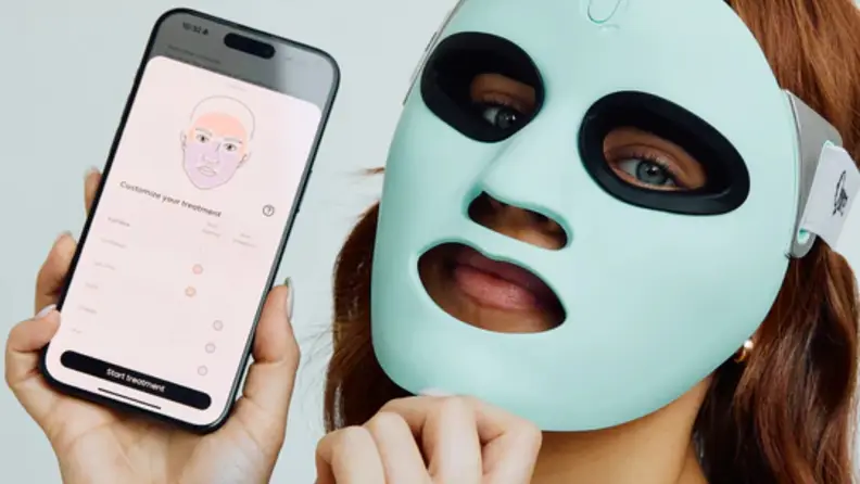 Woman wears Qure Q-Rejuvalight Pro Mask with Qure Skincare app open