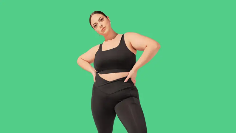 A model wearing a black sports bra.