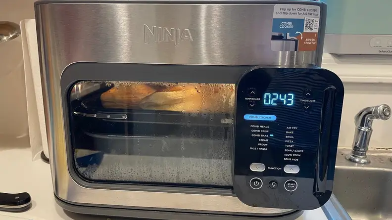 Baked goods being baked inside of the Ninja Combi Multicooker that sits on top of a counter.