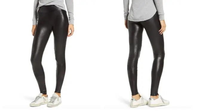 Woman wearing a light gray shirt and black shiny leather leggings