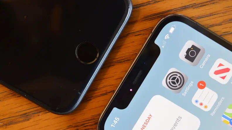 Two iPhones on a brown table