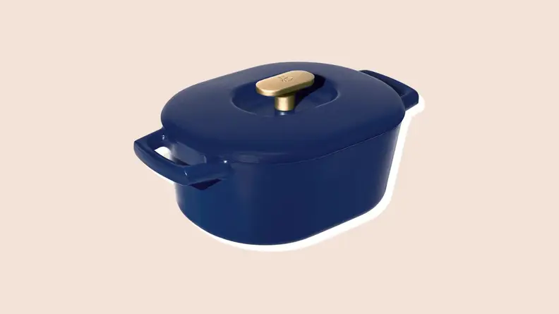 Product shot of navy colored dutch oven from the Beautiful by Drew Barrymore Kitchen Appliances line.