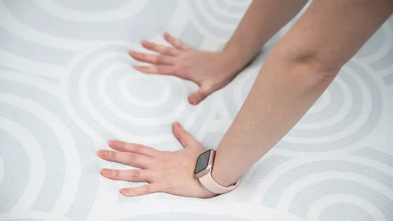 A pair of hands on the Serta Perfect Sleeper