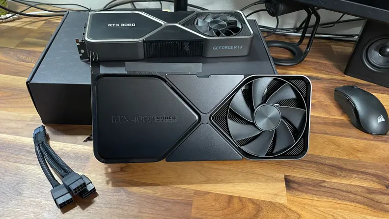 A black graphics card next to a silver 3080