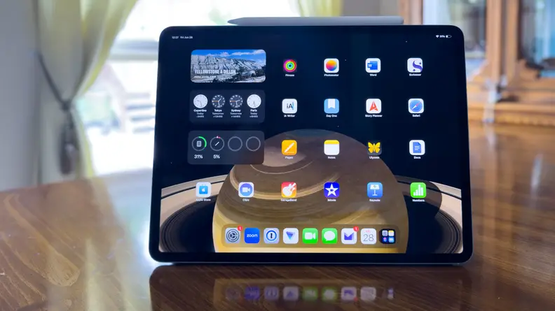 A 13-inch iPad Air sitting on a table in a dining room.