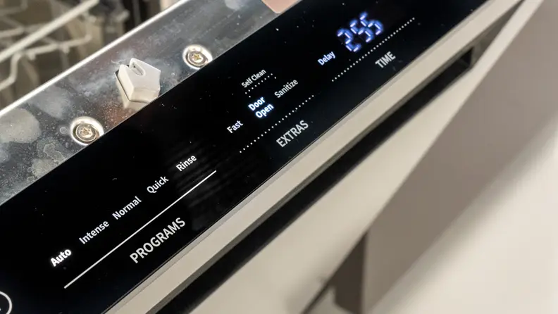 A close-up of the Hisense HUI6220XCUS dishwasher's touch buttons, located on the top edge of the door.