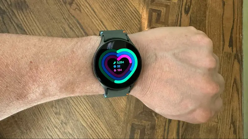 Close-up of a wrist wearing the smartwatch displaying a heart monitor.