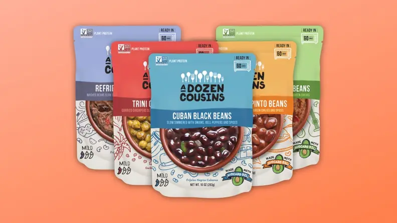 Five assorted flavors of colorful pre-packaged beans from A Dozen Cousins are arranged on an orange gradient background.