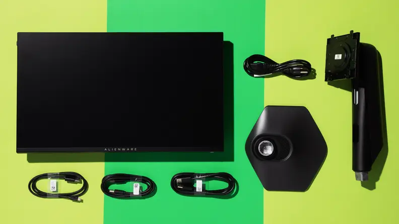Deconstructed Alienware AW2523HF monitor surrounded by four power cords and the base portion.