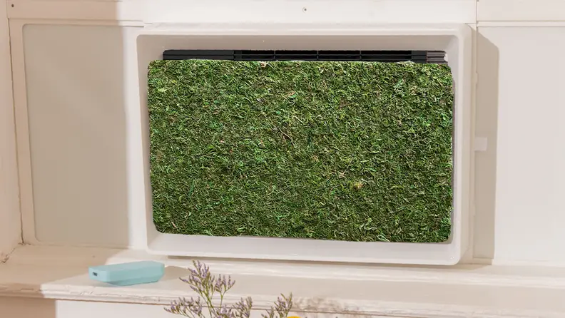 The green front panel of the A/C unit fully installed.