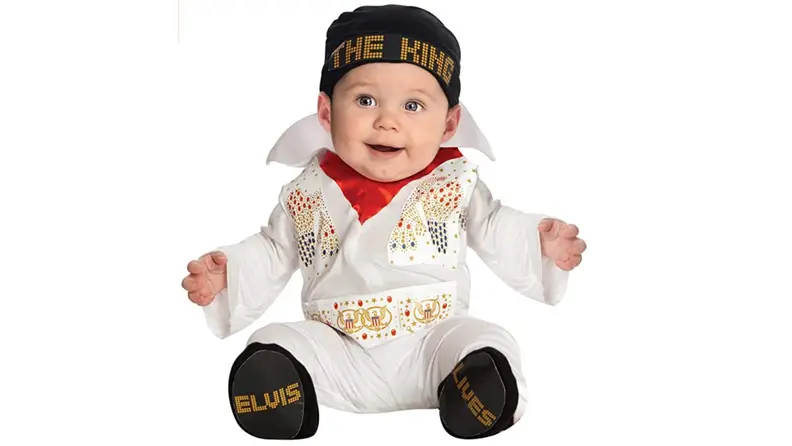 A baby dressed in an Elvis costume.