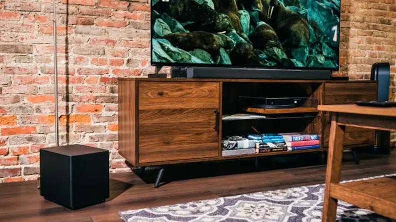 Television sitting  on a TV stand in living room.