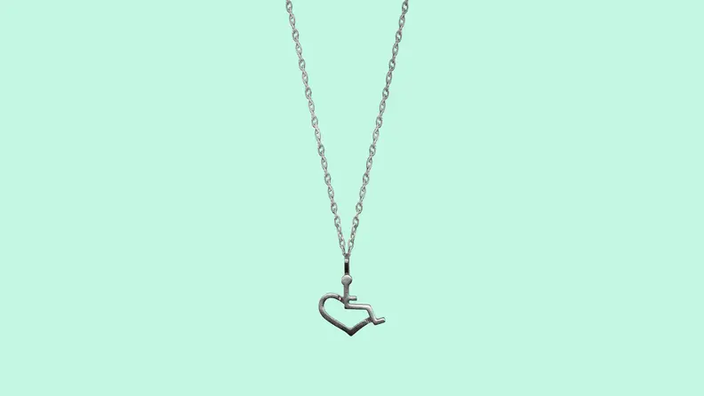 The 3E Love necklace on a green background.