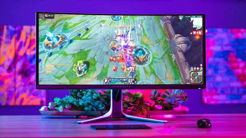 A monitor on top of a desk with a colored background