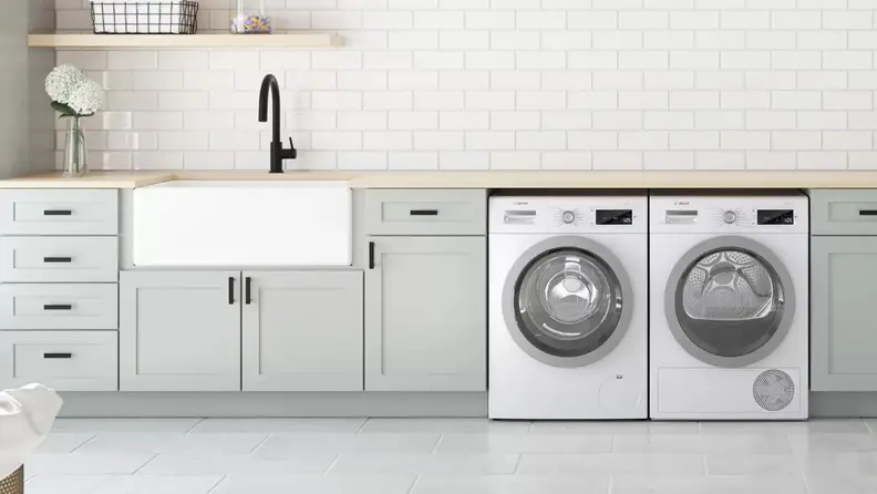 Matching washer and dryer in modern laundry room.