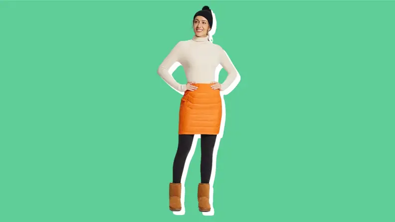 A model wears an orange puffer skirt.