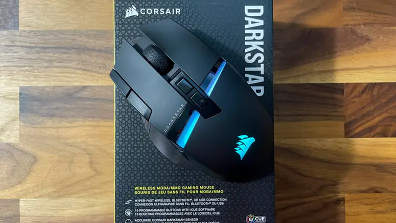 A bird's eye view of the Corsair Darkstar Wirless mouse on top of the product box.