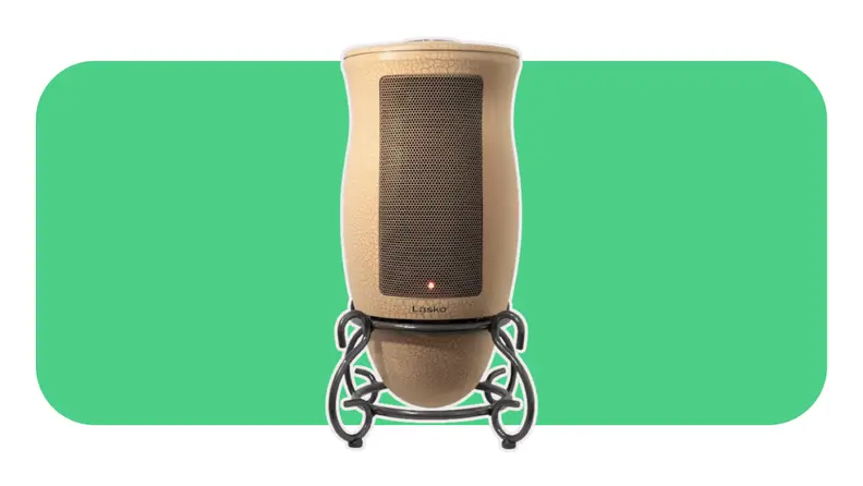 A brown Lasko 6435 space heater on a green background.