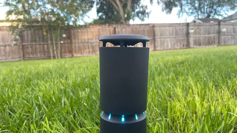 The LlV mosquito repeller sitting in the ground displaying blue lighs