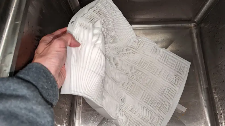 A standard HEPA filter falling apart during washing.