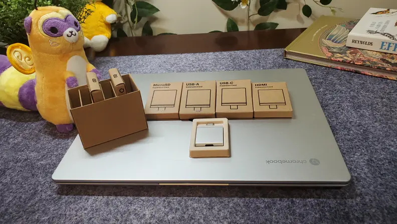 Five different HDMI and USB port pockets on top of the Framework Chrome laptop.
