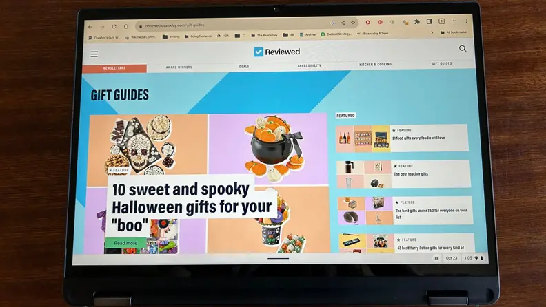 The laptop's monitor in tablet mode displaying the home page of Reviewed.com